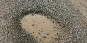 what causes potholes in your driveway